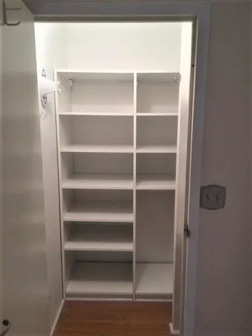 a view of walk in closet with empty racks