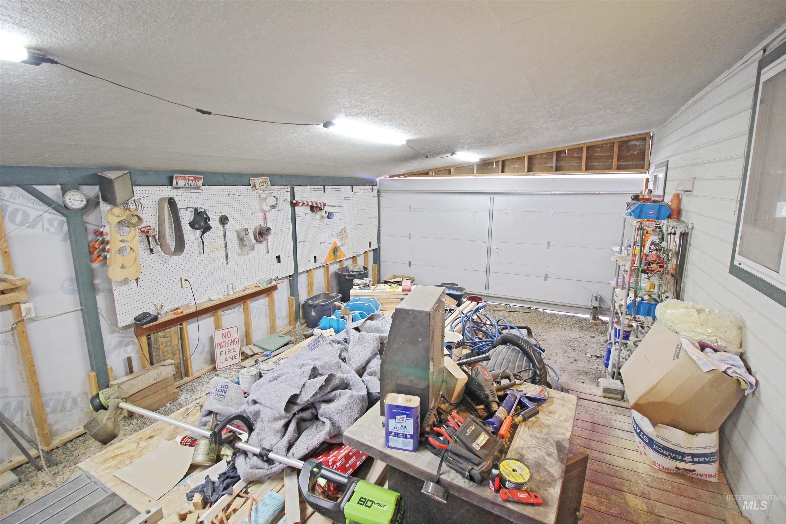 1265 Pioneer Road Weiser, ID 83672 - Photo 23 of 29 Garage space with a roll-up door and a side window
