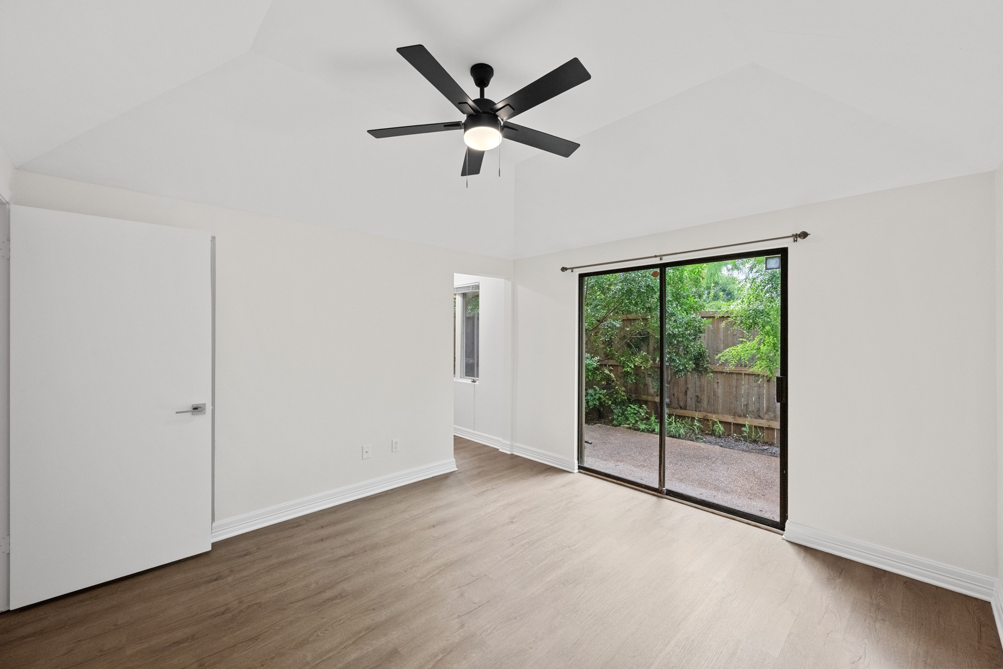 409 East 38th Street, Unit 101 Austin, TX 78705 - Photo 13 of 27 Primary Bedroom with of view hallway to bathroom and walk in closet. Door in picture is a secondary closet.