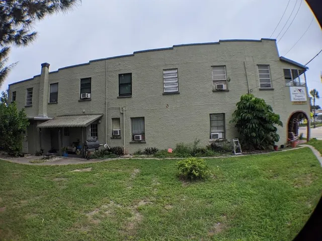 a backyard of a house with table and chairs