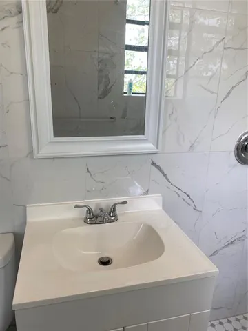 a bathroom with a sink and a window