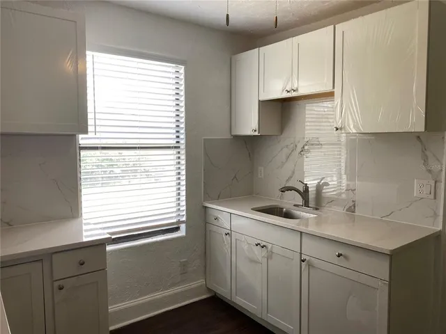 a kitchen with appliances cabinets and a window