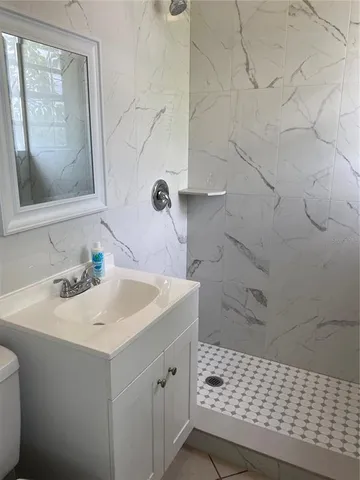 a bathroom with a sink a toilet and mirror