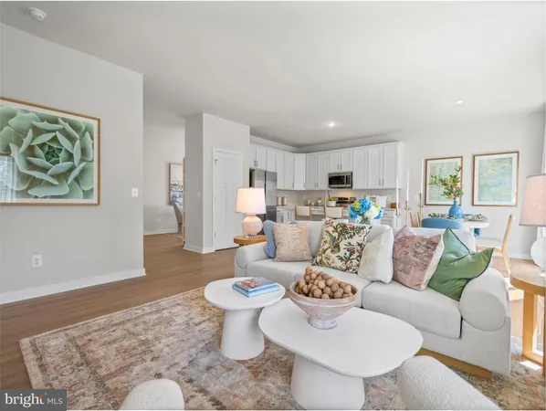 a living room with furniture and a dining table with rug
