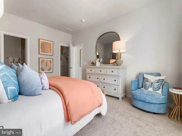 a bedroom with a bed and dresser