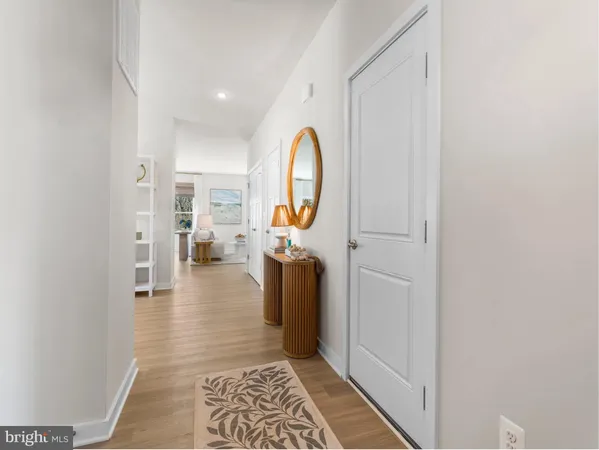 a view of a bathroom with mirror and a sink