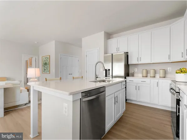 a kitchen with white cabinets sink and white appliances