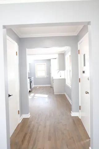 a kitchen with white cabinets and a window