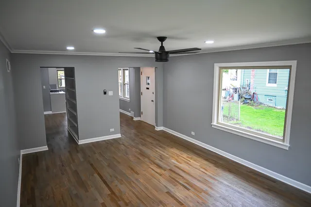 a kitchen with granite countertop a stove and white cabinets