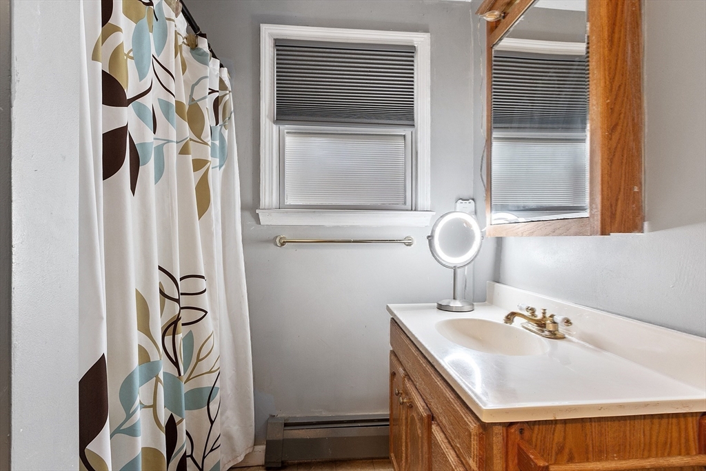 4.5 Old Battery Road Townsend, MA 01474 - Photo 16 of 42 a bathroom with a sink and mirror with bathtub