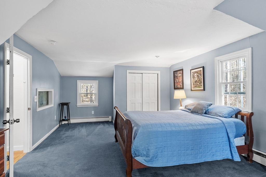 4.5 Old Battery Road Townsend, MA 01474 - Photo 18 of 42 a bedroom with a large bed a chandelier and windows