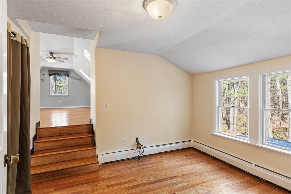 4.5 Old Battery Road Townsend, MA 01474 - Photo 19 of 42 a view of an empty room with wooden floor and a window