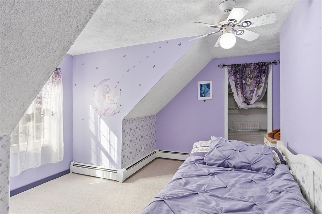 4.5 Old Battery Road Townsend, MA 01474 - Photo 24 of 42 a bedroom with a large bed and a chandelier