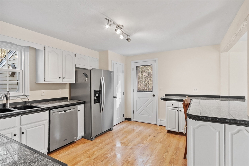 4.5 Old Battery Road Townsend, MA 01474 - Photo 4 of 42 a kitchen with white cabinets and refrigerator