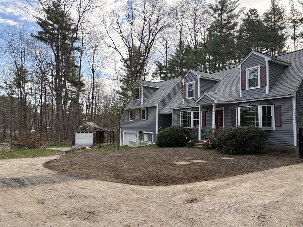 4.5 Old Battery Road Townsend, MA 01474 - Photo 42 of 42 a front view of a house with a yard and trees
