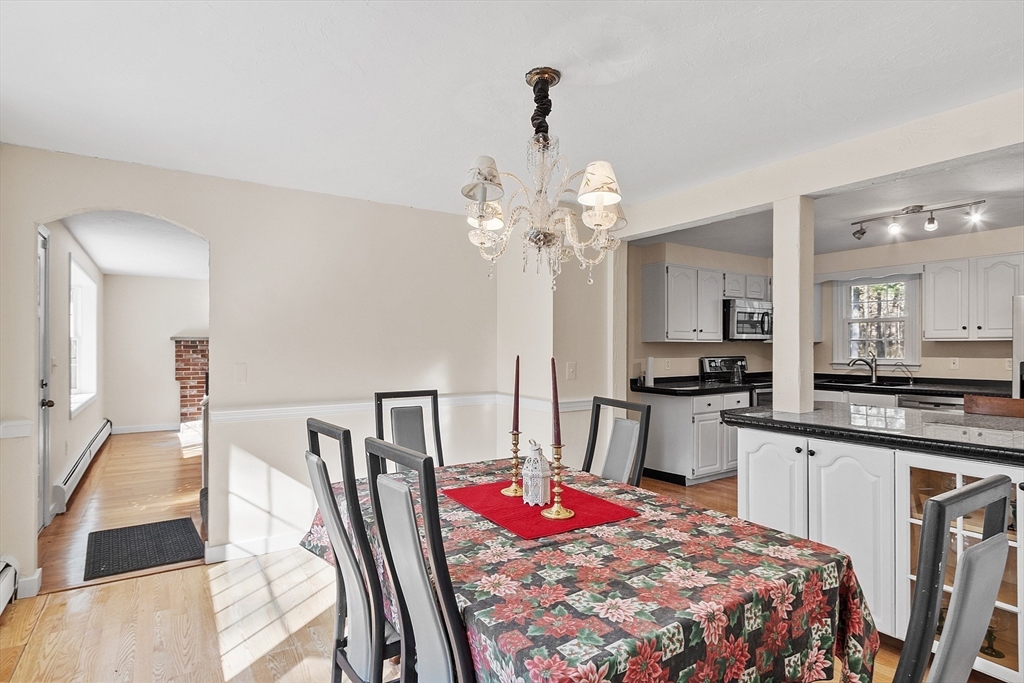 4.5 Old Battery Road Townsend, MA 01474 - Photo 6 of 42 a bedroom with a bed and a large mirror with wooden floor