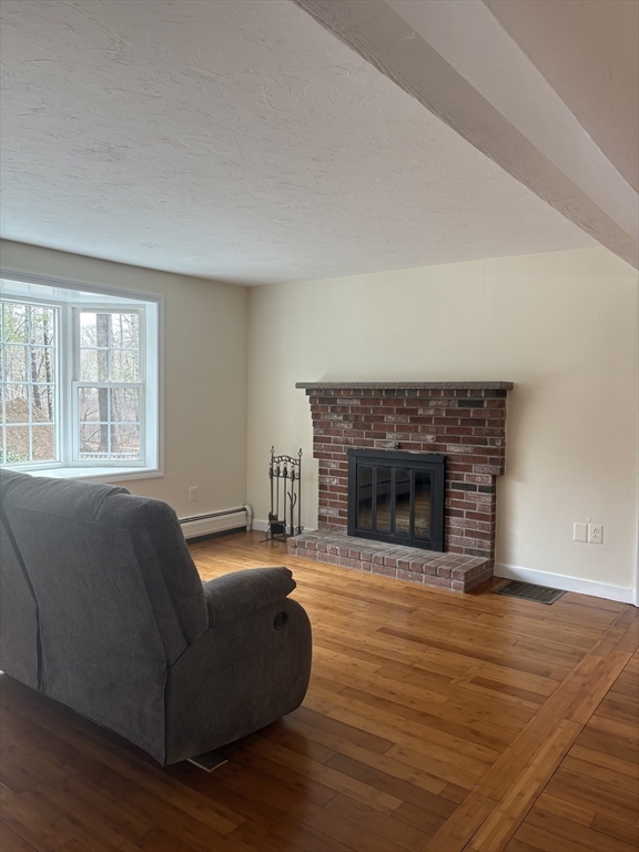 4.5 Old Battery Road Townsend, MA 01474 - Photo 9 of 42 a living room with furniture and a fireplace