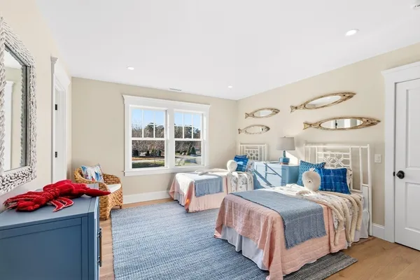 a bedroom with two beds and a window