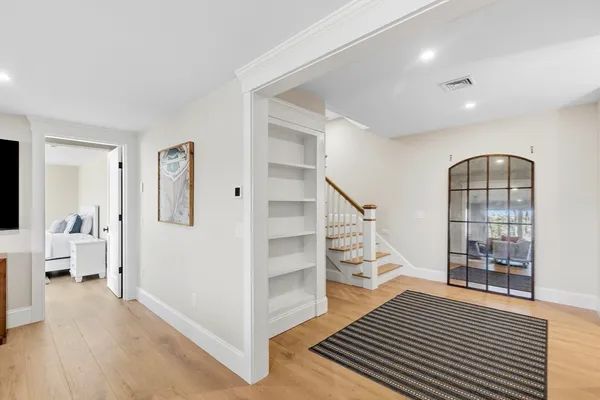 a view of entryway and hall with wooden floor