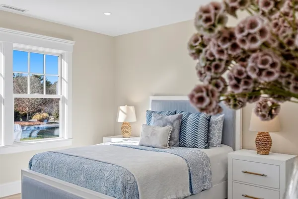 a bedroom with bed and a painting on the wall