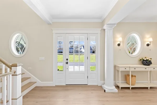 a view of a hallway with entryway wooden floor and front door