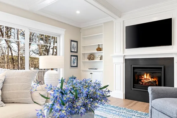 a living room with a flat screen tv and a fireplace