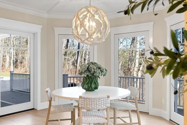 a view of a dining room with furniture and chandelier