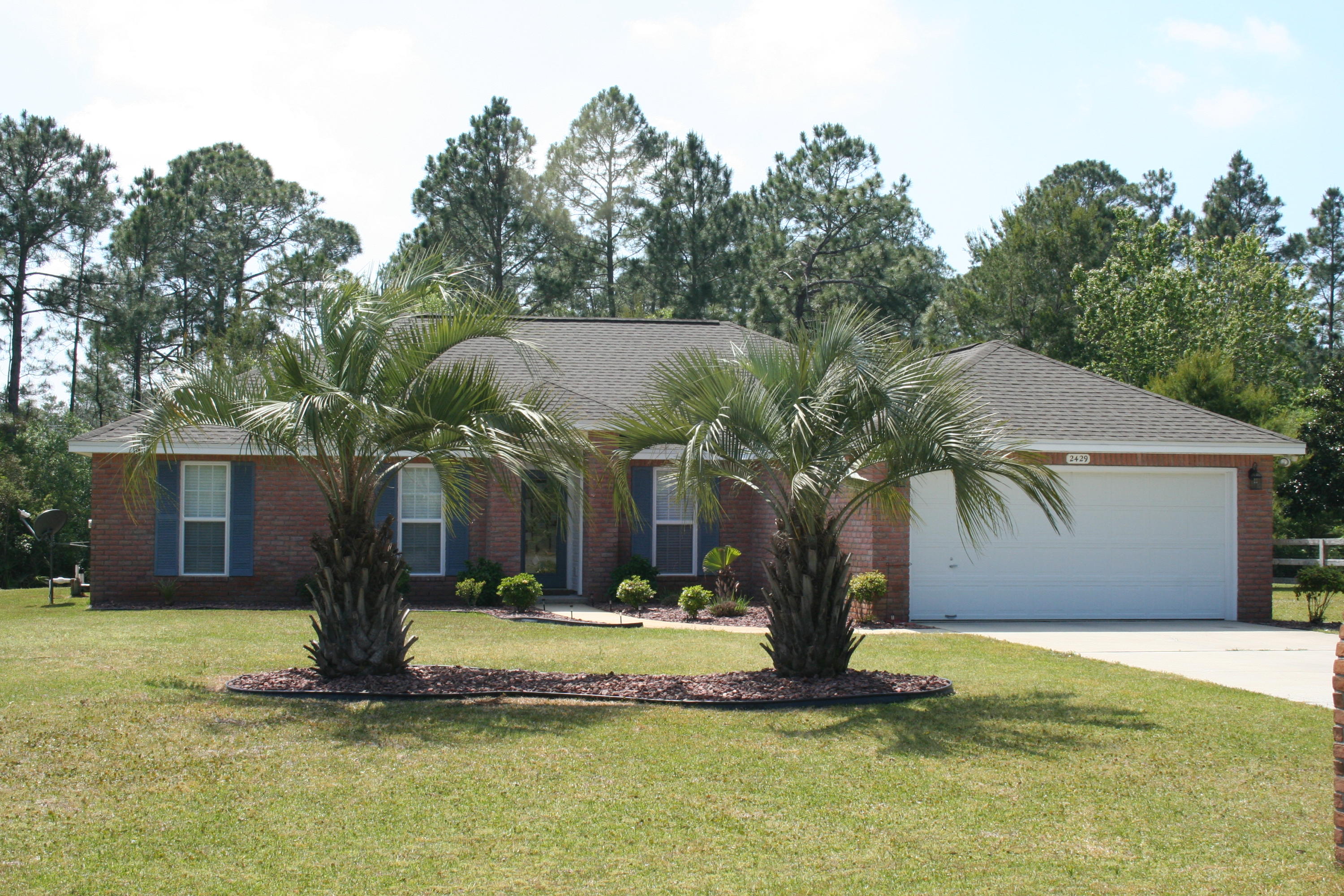 2429 Valley Road Navarre, FL 32566 - Photo 1 of 31 a front view of a house with a yard