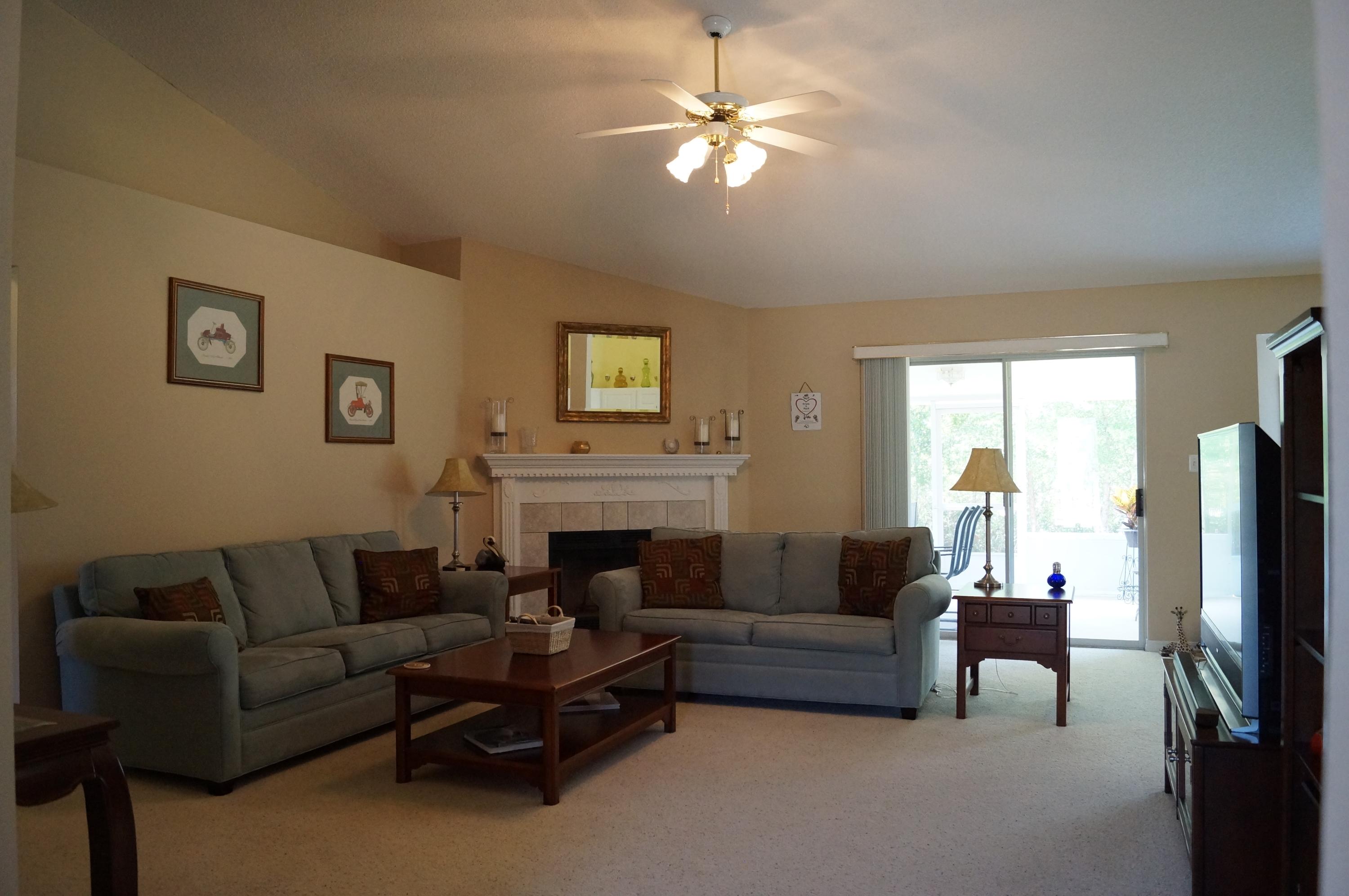 2429 Valley Road Navarre, FL 32566 - Photo 11 of 31 a living room with furniture a fireplace and a flat screen tv