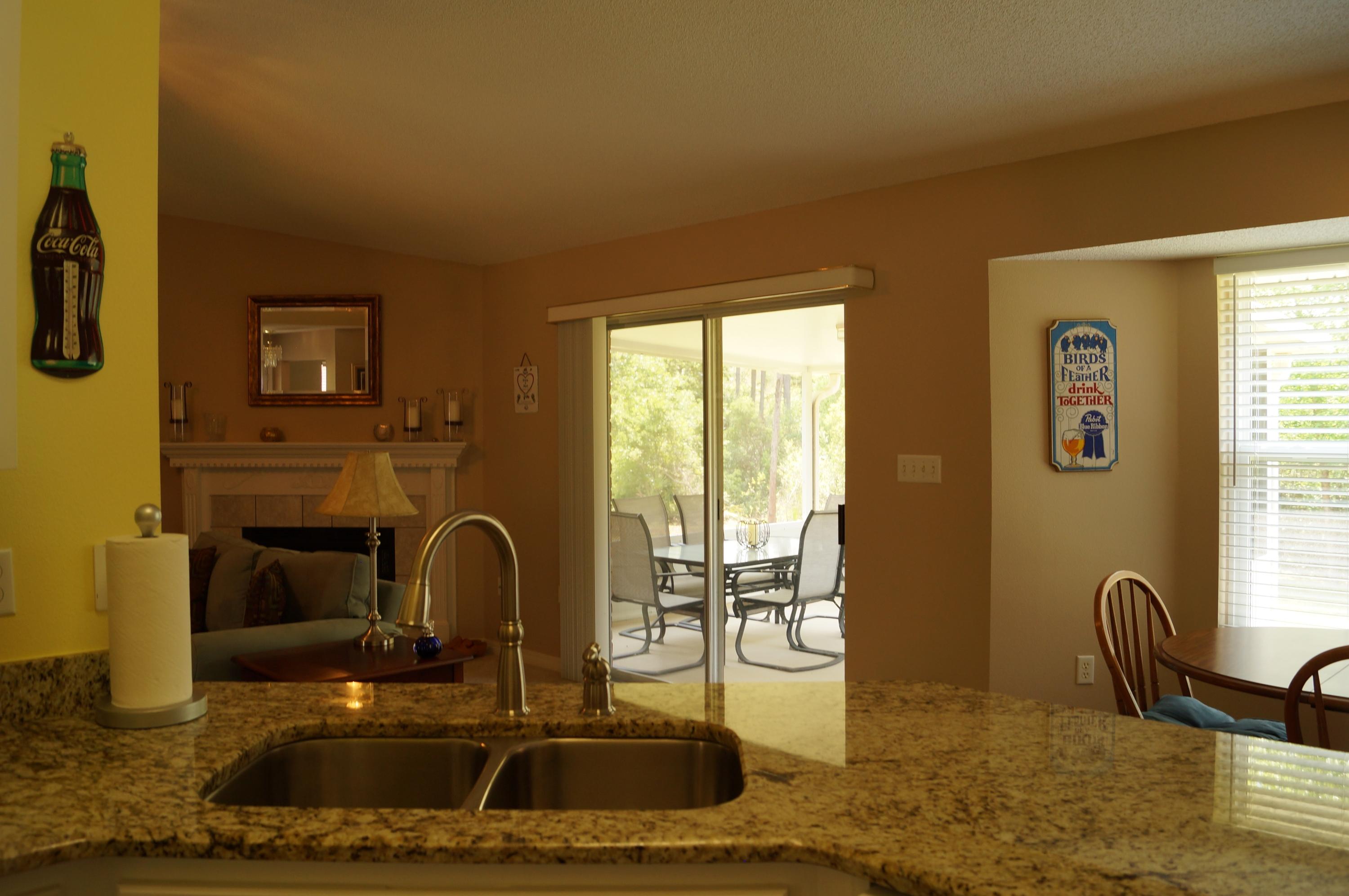 2429 Valley Road Navarre, FL 32566 - Photo 15 of 31 a kitchen with granite countertop a sink and a stove top oven