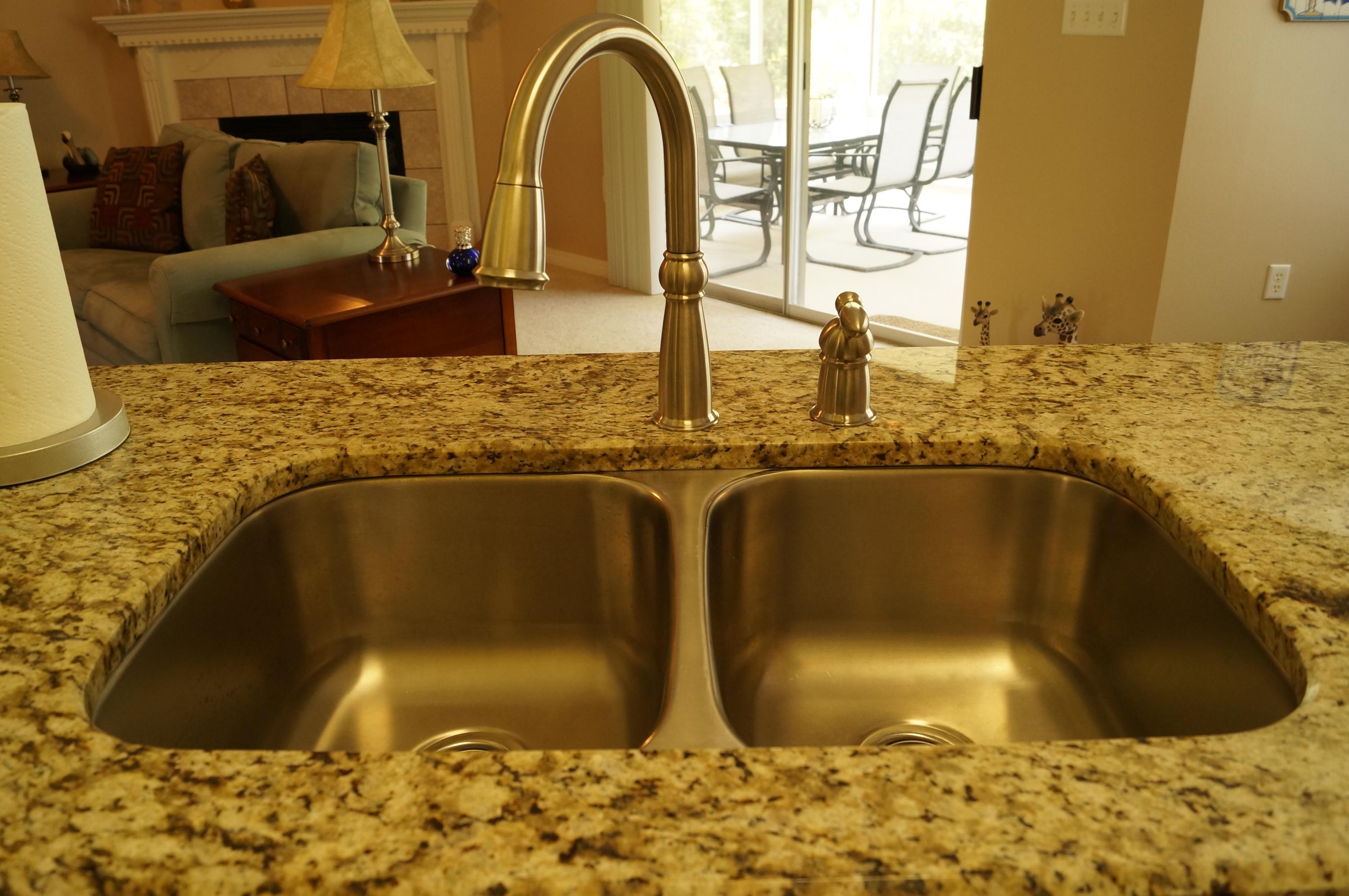 2429 Valley Road Navarre, FL 32566 - Photo 16 of 31 a bathroom with a granite countertop sink and a bathtub