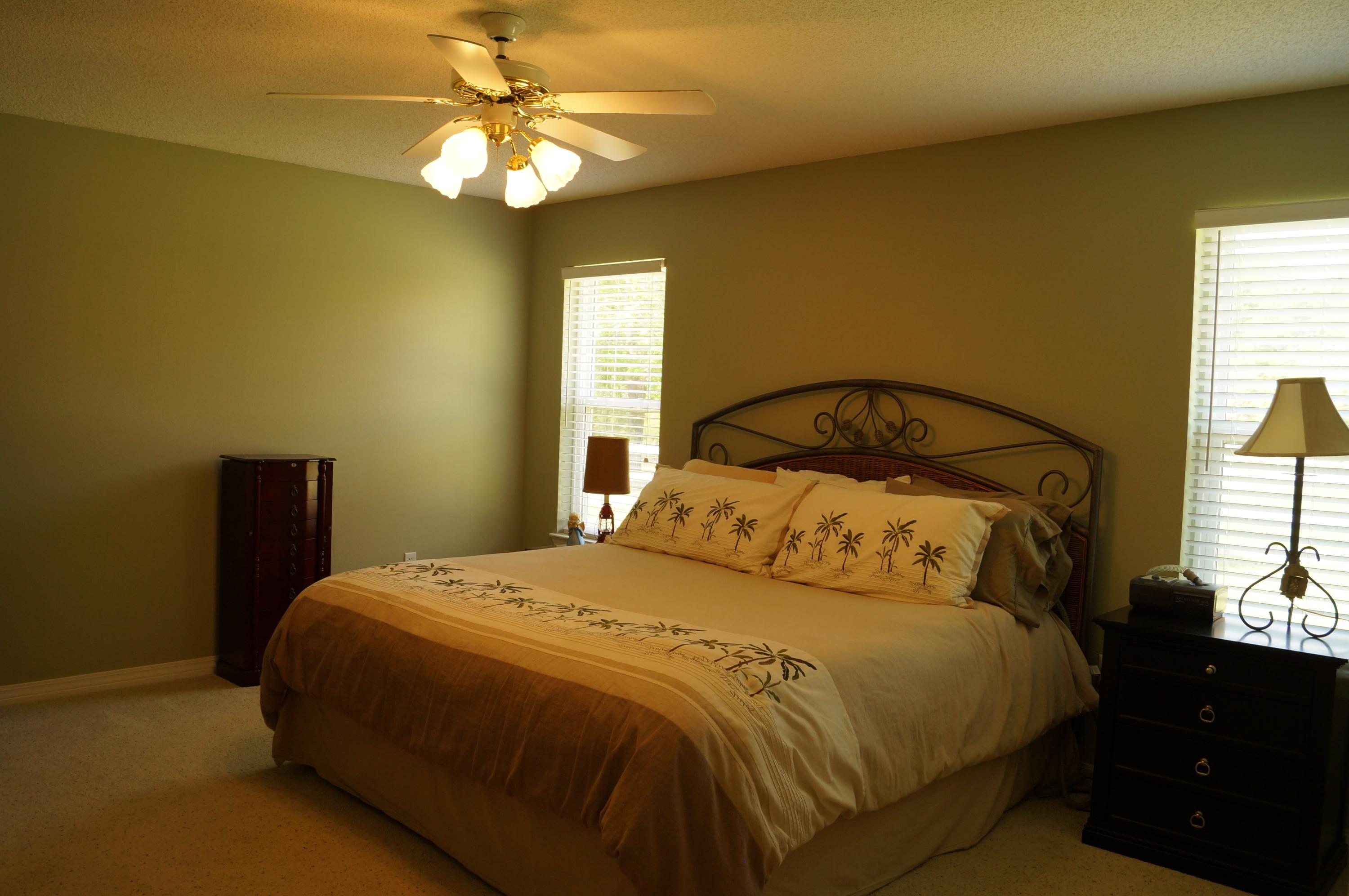 2429 Valley Road Navarre, FL 32566 - Photo 19 of 31 a bedroom with a bed and a chandelier