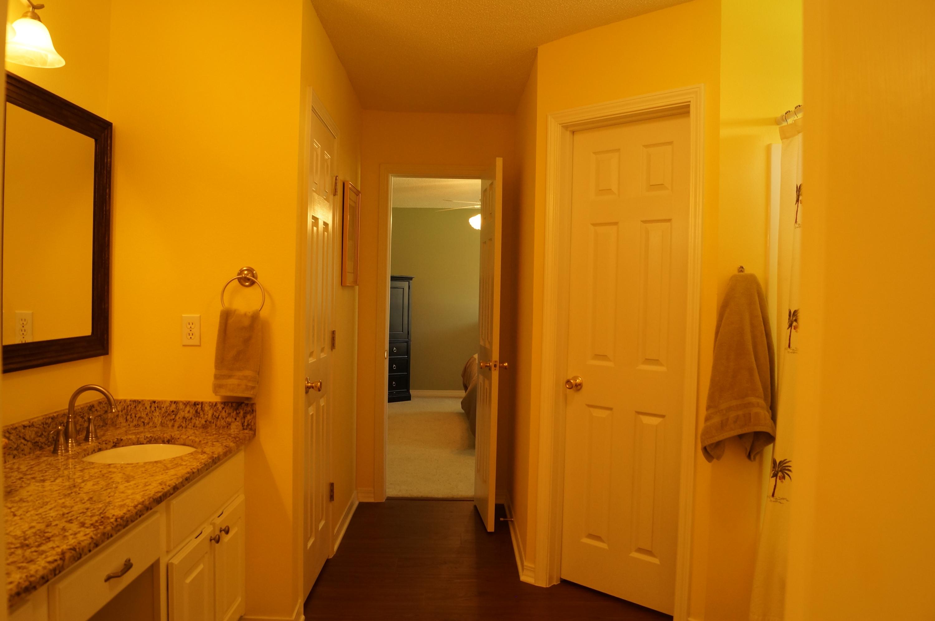 2429 Valley Road Navarre, FL 32566 - Photo 23 of 31 a bathroom with a granite countertop sink and a mirror