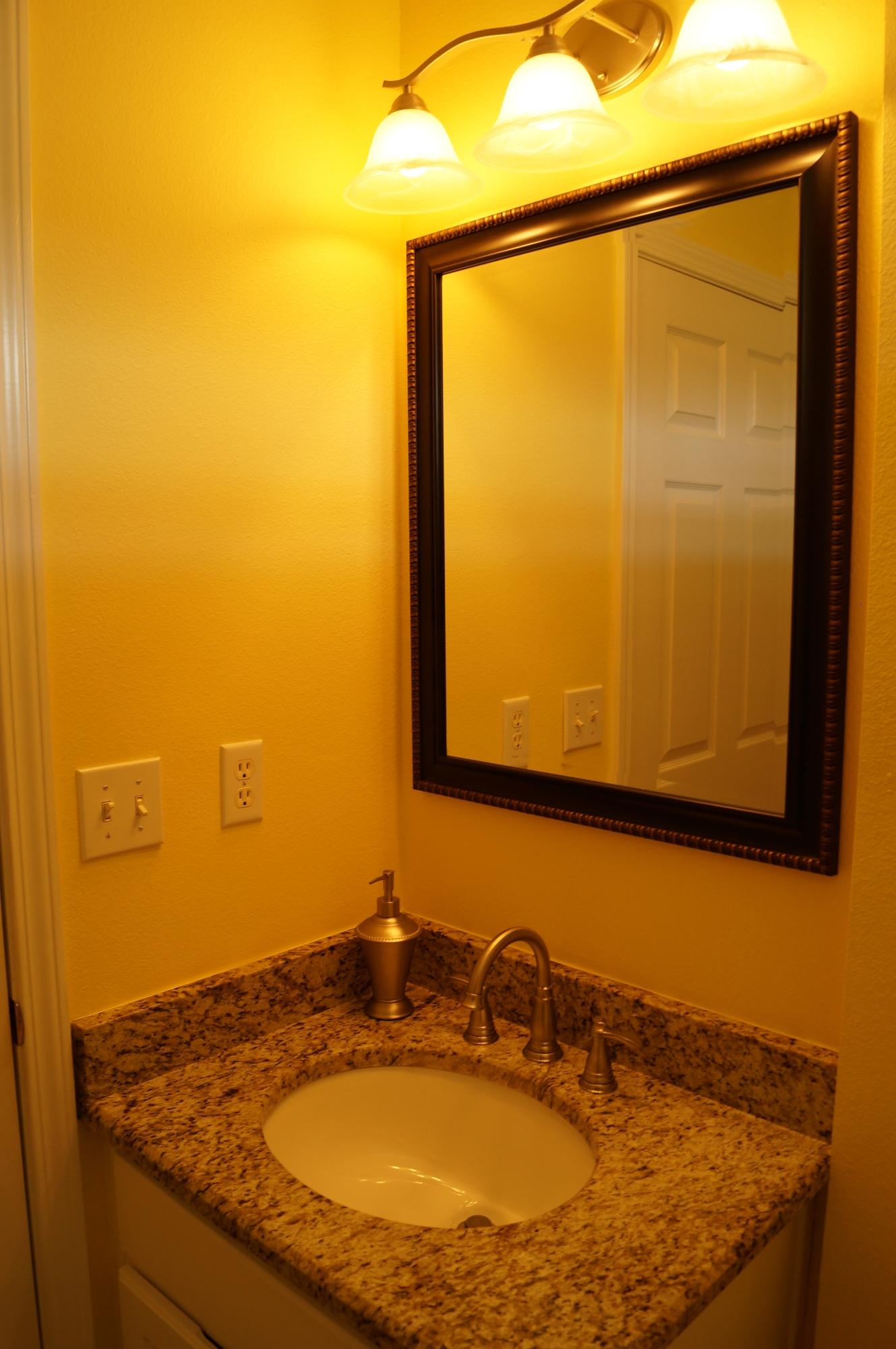 2429 Valley Road Navarre, FL 32566 - Photo 26 of 31 a bathroom with a granite countertop sink and a mirror