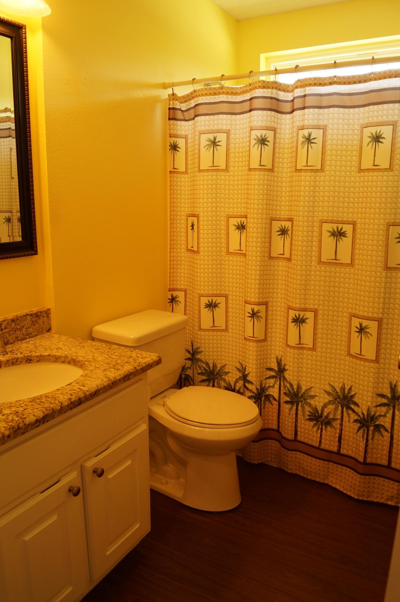 2429 Valley Road Navarre, FL 32566 - Photo 28 of 31 a bathroom with a granite countertop toilet a sink and a shower