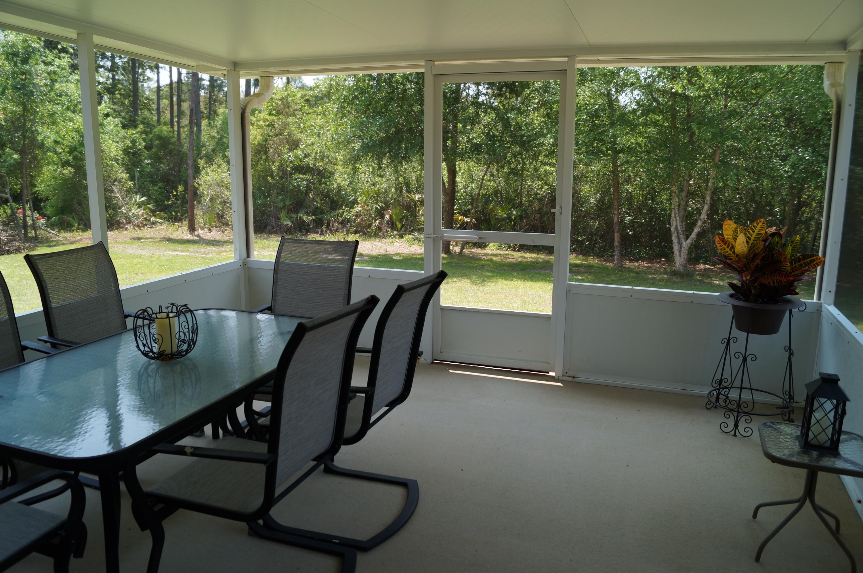 2429 Valley Road Navarre, FL 32566 - Photo 30 of 31 a view of a dining room with furniture window and outside view