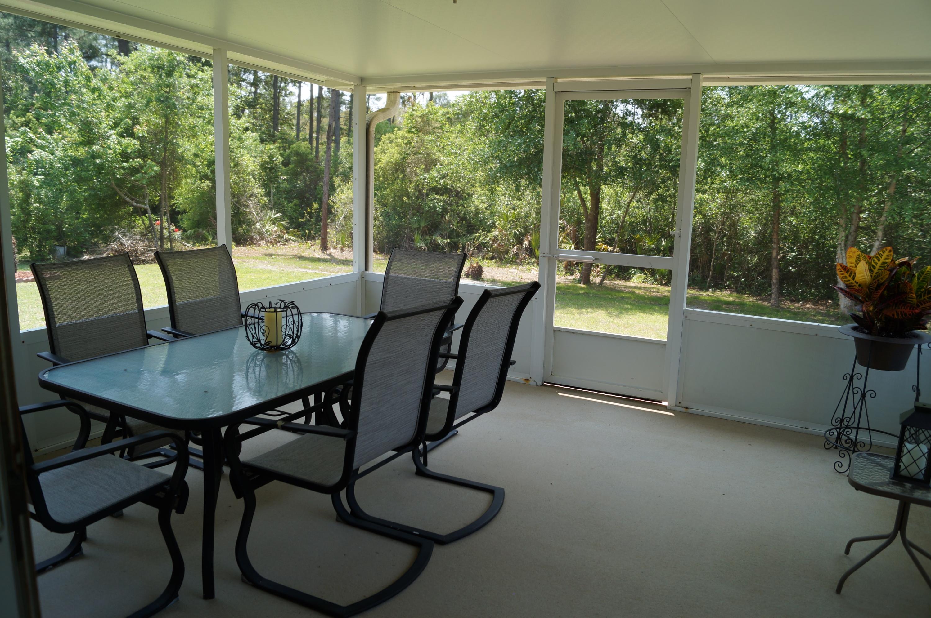 2429 Valley Road Navarre, FL 32566 - Photo 31 of 31 a view of a dining room with furniture window and outside view