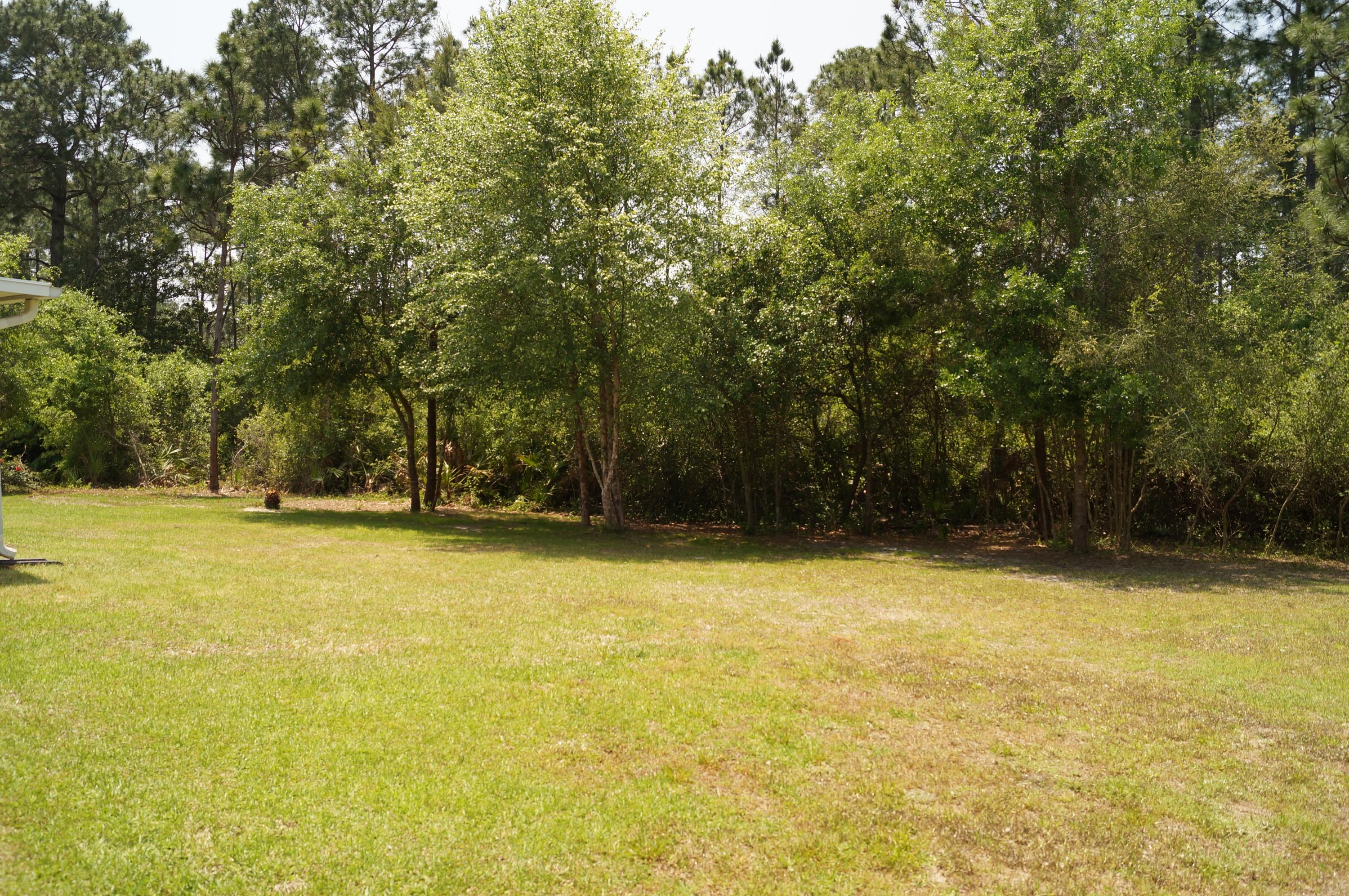 2429 Valley Road Navarre, FL 32566 - Photo 5 of 31 a view of a swimming pool with an outdoor space