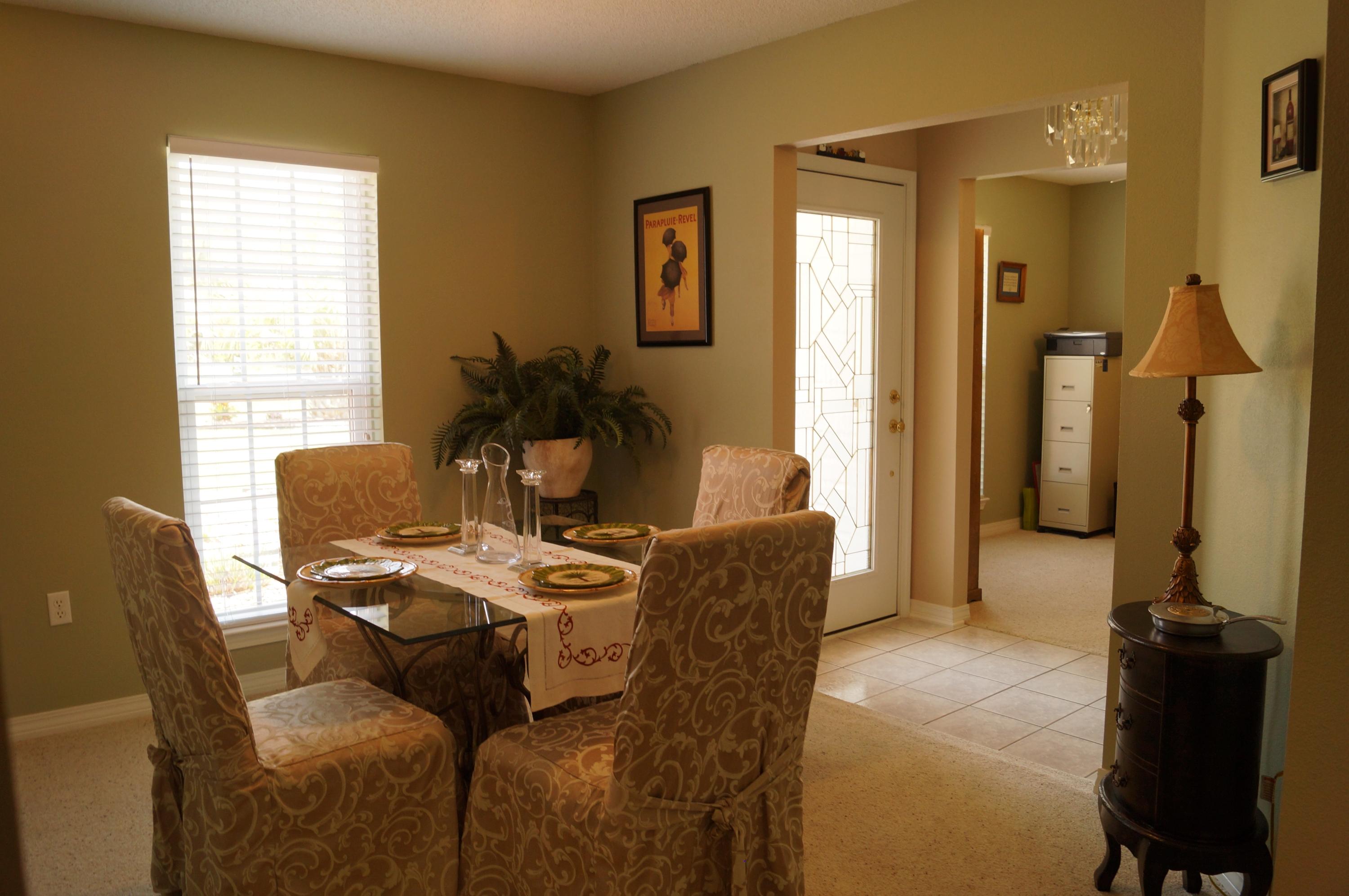2429 Valley Road Navarre, FL 32566 - Photo 10 of 31 a living room with furniture a window and a chandelier