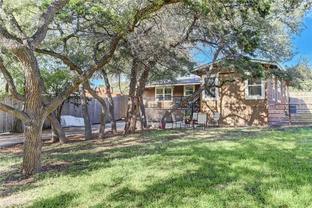 a backyard of a house with table and chairs