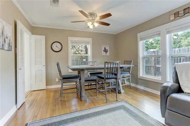 a kitchen with a table chairs refrigerator and cabinets