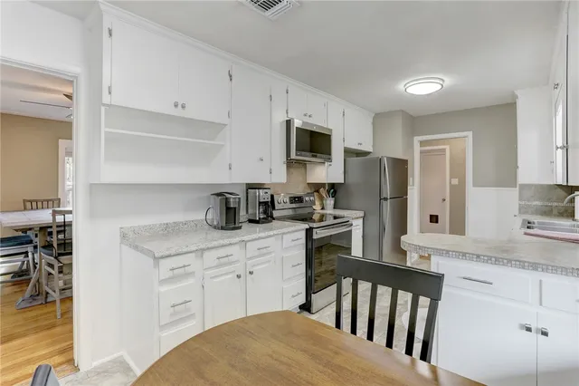 a kitchen with stainless steel appliances granite countertop a refrigerator stove and microwave