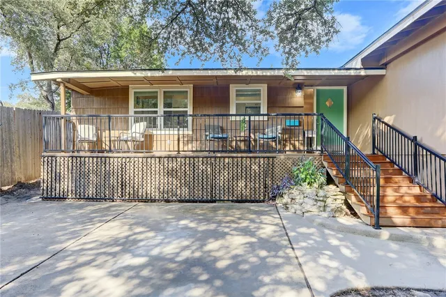 a view of a porch with wooden floor and iron fence