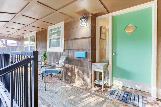 a view of a roof deck with wooden floor and fence