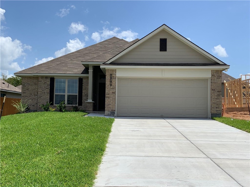 139 Bates Court Huntsville, TX 77320 - Photo 1 of 21 a front view of a house with a yard and garage