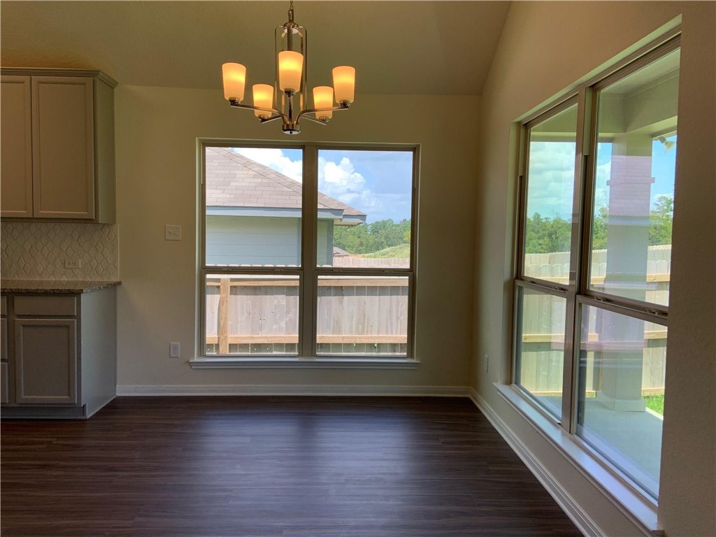 139 Bates Court Huntsville, TX 77320 - Photo 12 of 21 a view of an empty room with wooden floor and a window