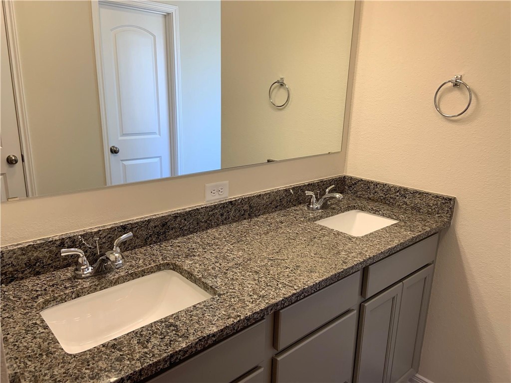 139 Bates Court Huntsville, TX 77320 - Photo 14 of 21 a bathroom with a granite countertop sink and a mirror