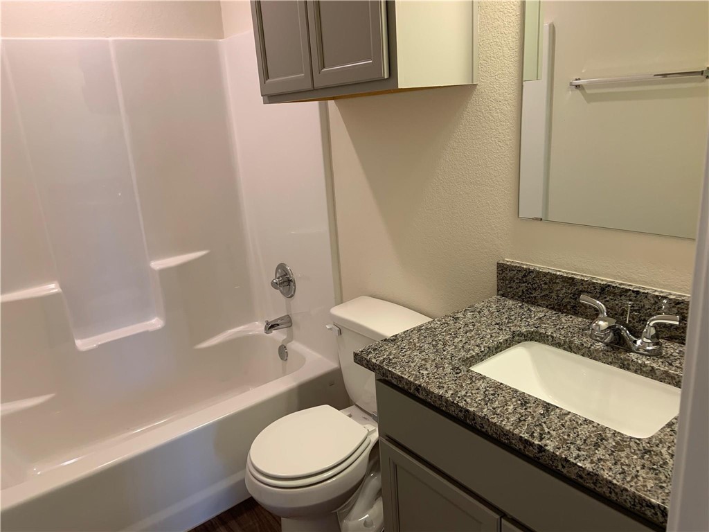 139 Bates Court Huntsville, TX 77320 - Photo 20 of 21 a bathroom with a granite countertop sink toilet and shower