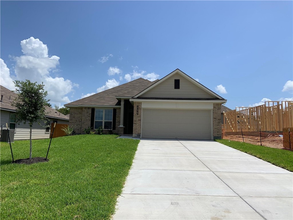 139 Bates Court Huntsville, TX 77320 - Photo 2 of 21 a front view of a house with a yard and garage