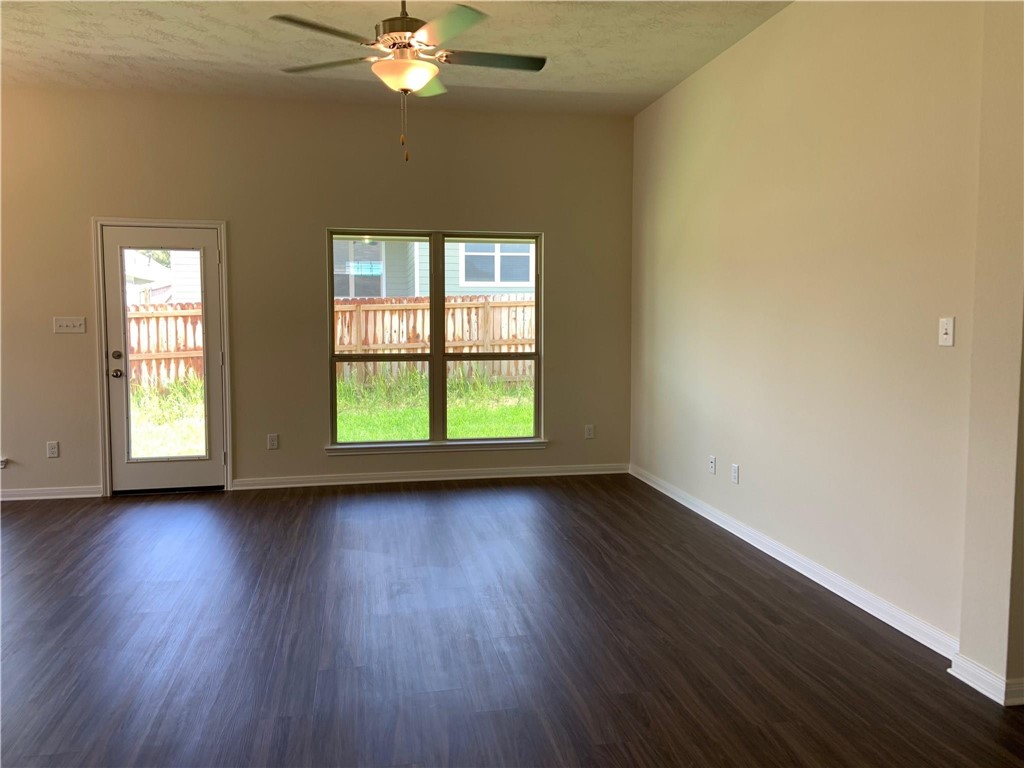139 Bates Court Huntsville, TX 77320 - Photo 6 of 21 a view of an empty room with wooden floor and a window